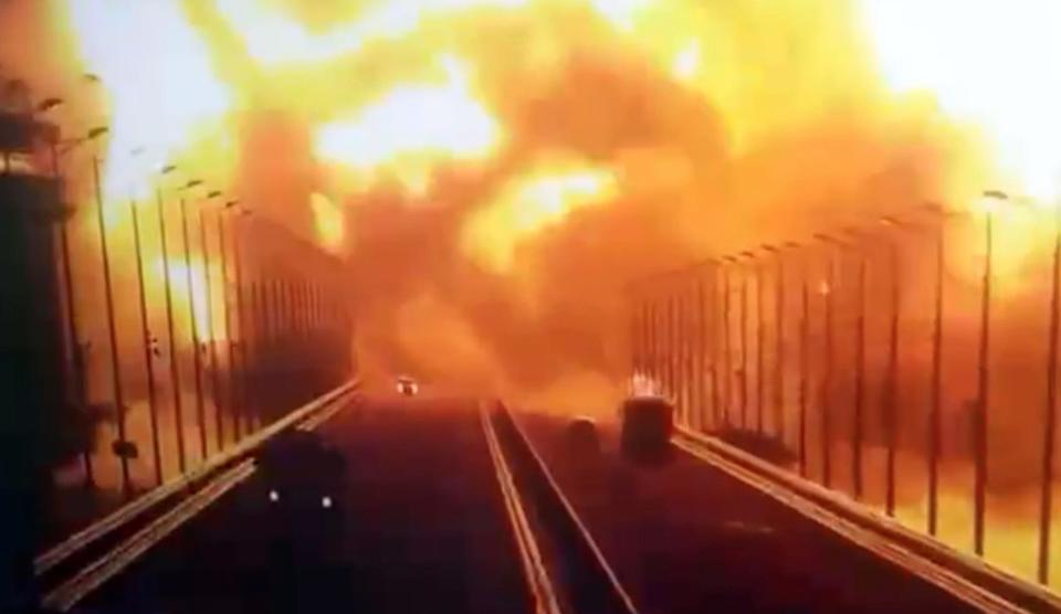 Flames and smoke rising up after an explosion at the Kerch bridge in the Kerch Strait, Crimea