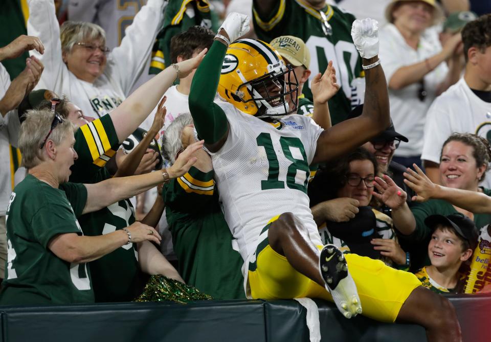 Green Bay Packers wide receiver <a class="link " href="https://sports.yahoo.com/nfl/players/40445" data-i13n="sec:content-canvas;subsec:anchor_text;elm:context_link" data-ylk="slk:Malik Heath;sec:content-canvas;subsec:anchor_text;elm:context_link;itc:0">Malik Heath</a> (18) does a Lambeau Leap during Family Night on Aug. 5, 2023, at Lambeau Field in Green Bay, Wis.