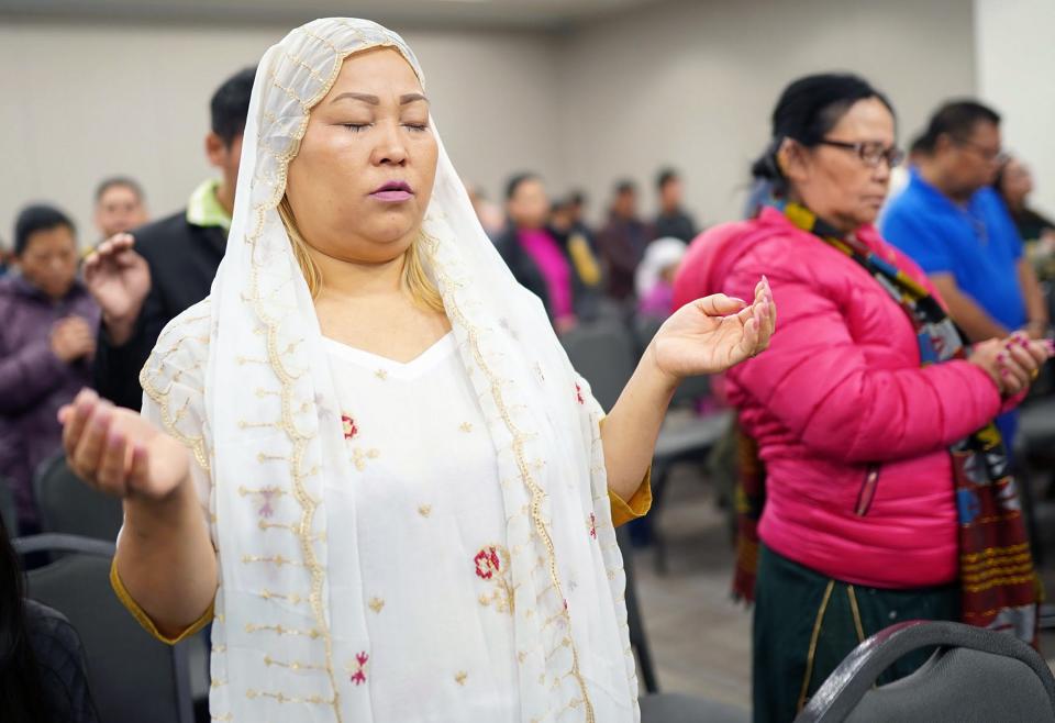 Dilu Raaya Rai worships at Christian Community Friends Church in Reynoldsburg on April 2. With Easter approaching, Pastor Norbu Tamang described his Bhutanese Nepali refugee community’s arrival in the U.S. as a kind of its own resurrection.