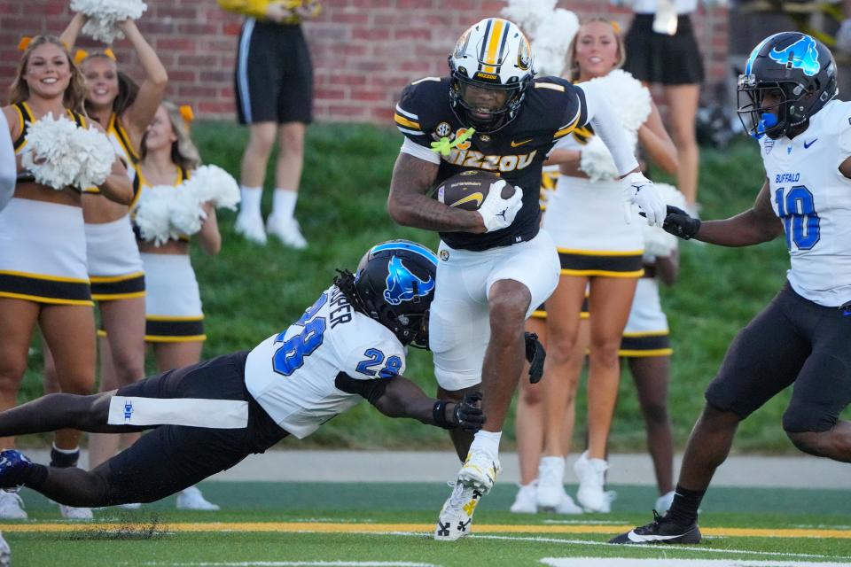 Sep 7, 2024; Columbia, Missouri, USA; Missouri Tigers wide receiver Theo Wease Jr. (1) runs the ball as Buffalo Bulls cornerback Marquis Cooper (28) attempts the tackle during the first half at Faurot Field at Memorial Stadium.