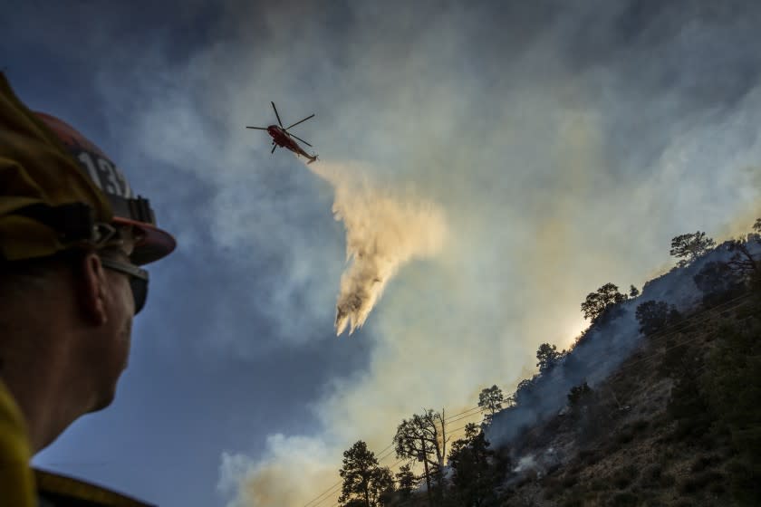 LLANO, CA - SEPTEMBER 20: Los Angeles County firefighter Captain Tom Lawson watches as a water-dropping helicopter makes a drop on the Bobcat fire as it continues to burn in the Angeles National Forest near Llano Sunday, Sept. 20, 2020. Some houses and structures were lost in the Bobcat fire but most were saved. (Allen J. Schaben / Los Angeles Times)