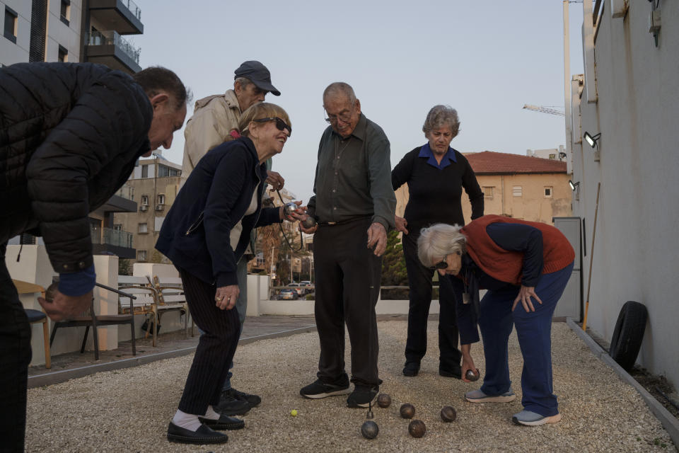 Yankale Cohen, 89, one of the founders of Kibbutz Nahal Oz, plays petanque with his neighbors at the assisted living facility in Bat Yam, Israel, Friday, Feb. 9, 2024, where he is staying after the Oct. 7, 2023, Hamas cross-border attack in Israel. (AP Photo/Leo Correa)