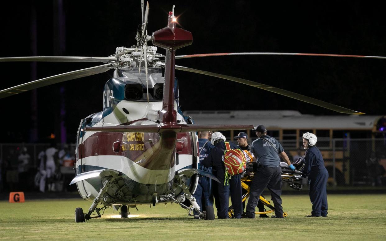 A shooting victim is loaded into Trauma Hawk on the field during a football field at Palm Beach Central High School in 2018. The gunfire sent players and fans screaming and stampeding in panic during the fourth quarter of the game at Palm Beach Central High