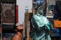 Jenney Vaverde, 42, views the solar eclipse at Times Square in Manhattan, New York, U.S., August 21, 2017. Location coordinates for this image are 40.7589° N, 73.9851° W. REUTERS/Shannon Stapleton