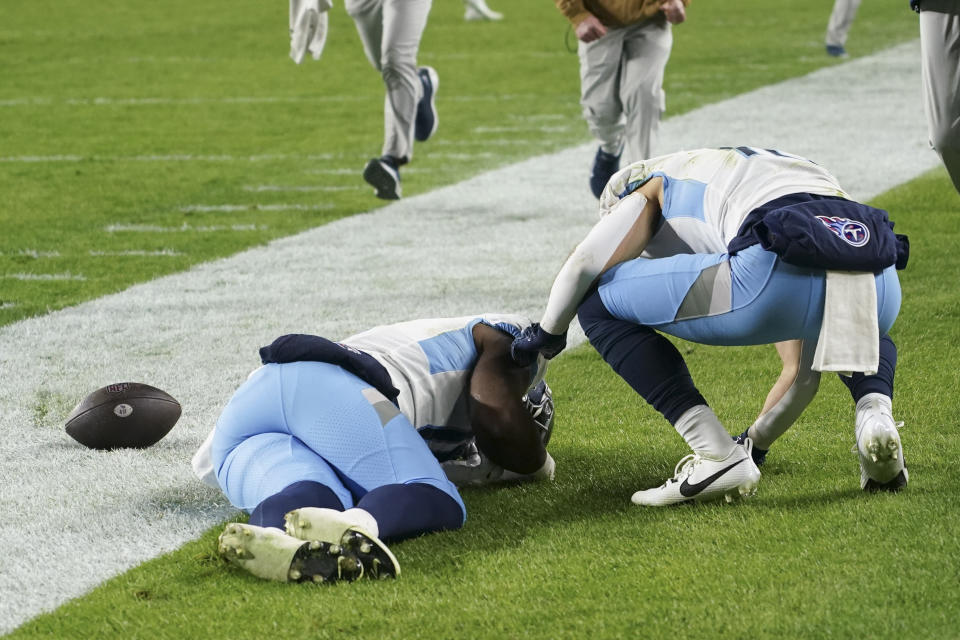 Tennessee Titans wide receiver Treylon Burks, left, lies on the field injured during the second half of an NFL football game against the Pittsburgh Steelers, Thursday, Nov. 2, 2023, in Pittsburgh. (AP Photo/Matt Freed)