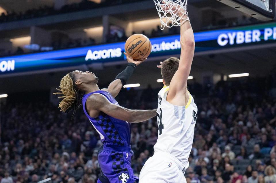 Sacramento Kings guard Keon Ellis (23) gets fouled by Utah Jazz center Walker Kessler (24) and makes both free throws in the first half of the NBA basketball game on Saturday, Dec. 16, 2023, at Golden 1 Center.
