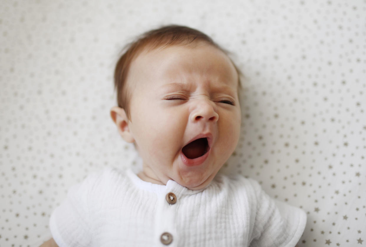 A 4 month old baby girl yawning Catherine Delahaye via Getty Images