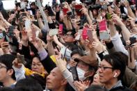 People take pictures of Japan's Emperor Naruhito as he leaves the Imperial Palace in Tokyo, Japan May 1, 2019. REUTERS/Kim Kyung-Hoon