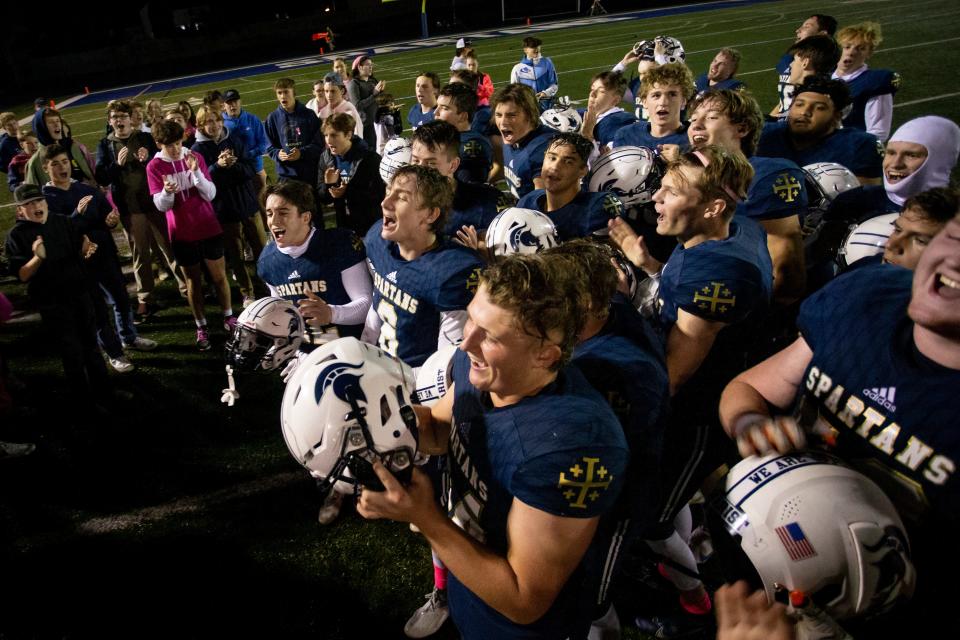 Marist players celebrate after defeating Junction City. The Marist Spartans defeated the Junction City Tigers 21-7 at Marist High School Friday, Oct. 28, 2022, in Eugene. 