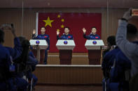 Chinese astronauts for the upcoming Shenzhou-17 mission, from left, Jiang Xinlin, Tang Hongbo, and Tang Shengjie wave as they arrive for a meeting with the press at the Jiuquan Satellite Launch Center in northwest China, Wednesday, Oct. 25, 2023. (AP Photo/Andy Wong)