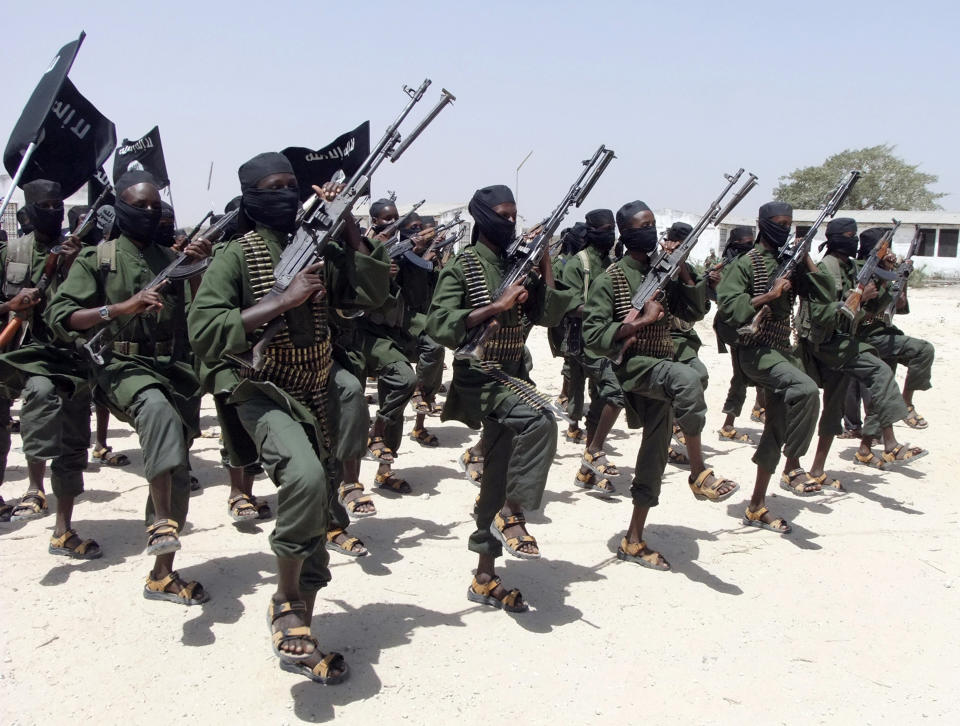 FILE - In this Thursday, Feb. 17, 2011 file photo, hundreds of newly trained al-Shabab fighters perform military exercises in the Lafofe area some 18 km south of Mogadishu, in Somalia. U.N. experts said in a report circulated Tuesday, Nov. 12, 2019 that al-Shabab extremists in Somalia remain "a potent threat" to regional peace and are manufacturing home-made explosives, expanding their revenue sources and infiltrating government institutions. (AP Photo/Farah Abdi Warsameh, File)