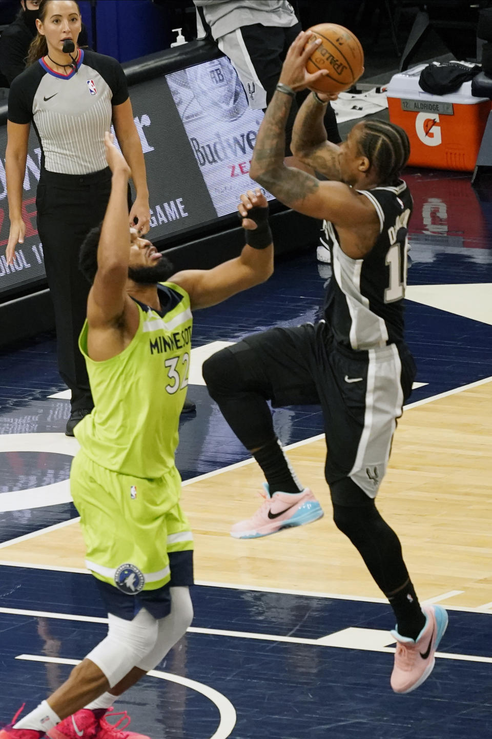 San Antonio Spurs' DeMar DeRozan, right, shoots over Minnesota Timberwolves' Karl-Anthony Towns in the second half of an NBA basketball game Saturday, Jan. 9, 2021, in Minneapolis. (AP Photo/Jim Mone)