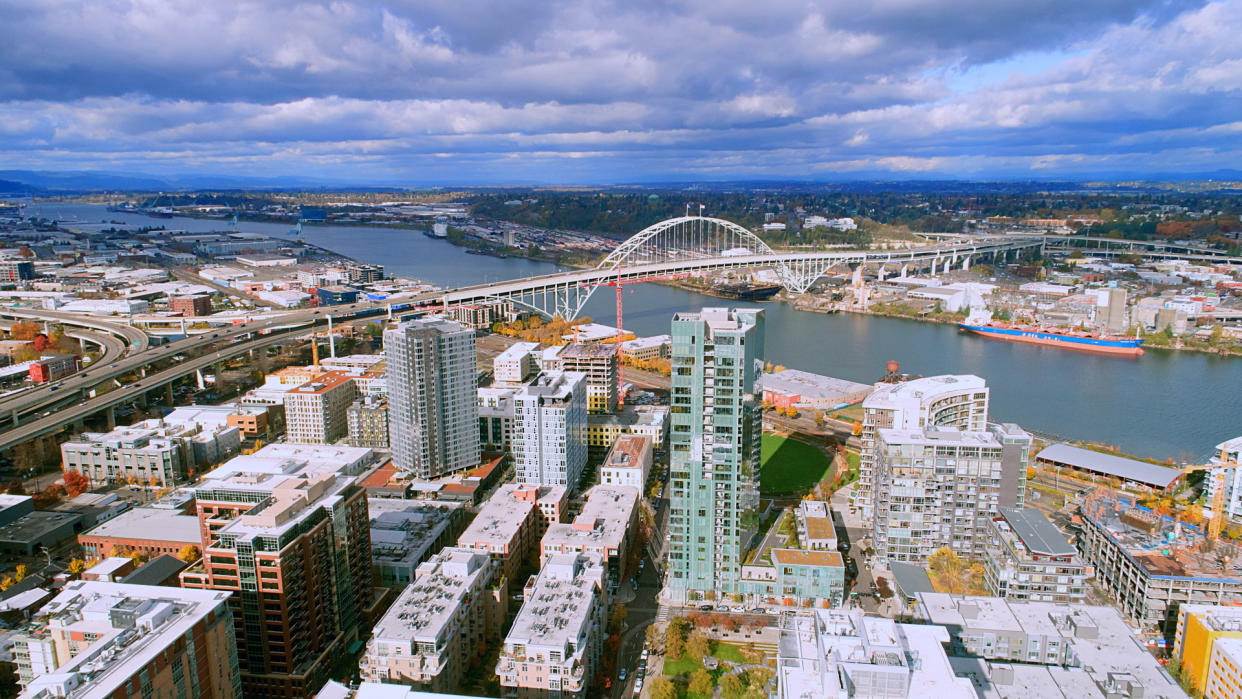 Unique aerial perspective of Fremont Bridge over the willamette river in the pearl district of downtown Portland Oregon on a perfect day.