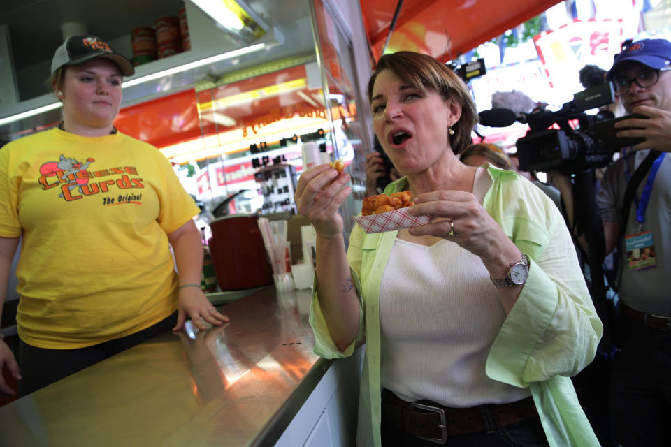 Sen. Amy Klobuchar (D-Minn.) eats cheese curds at the state fair on Aug. 10.