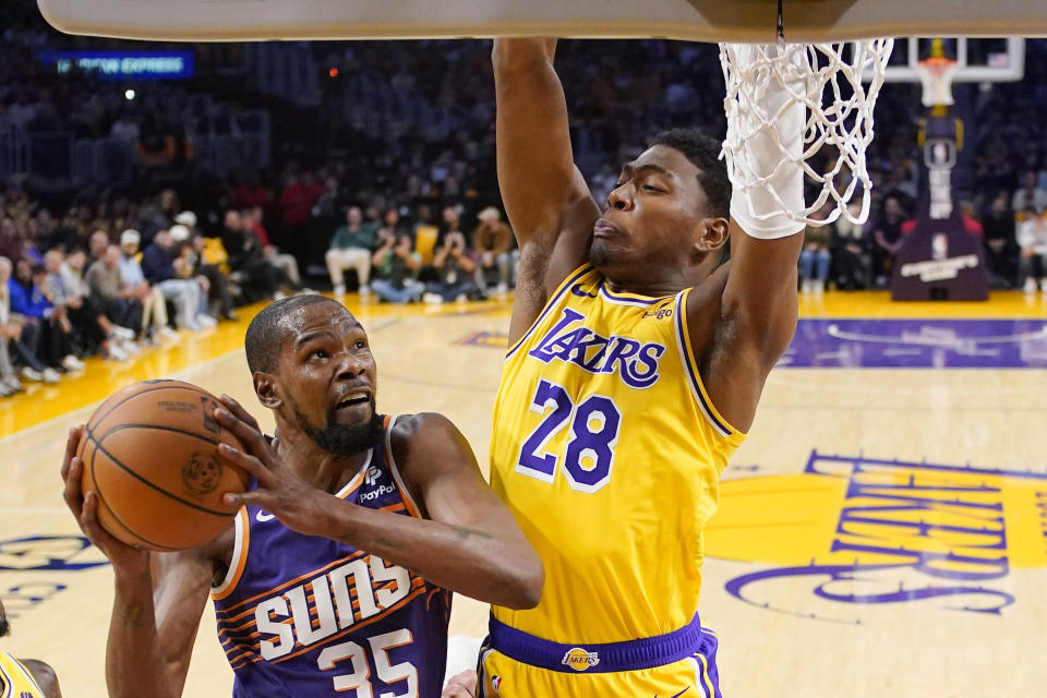 Phoenix Suns forward Kevin Durant, left, shoots as Los Angeles Lakers forward Rui Hachimura defends during the first half of an NBA basketball game Thursday, Oct. 26, 2023, in Los Angeles. (AP Photo/Mark J. Terrill)