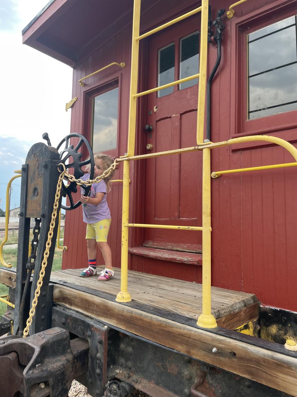 The author's daughter exploring a train