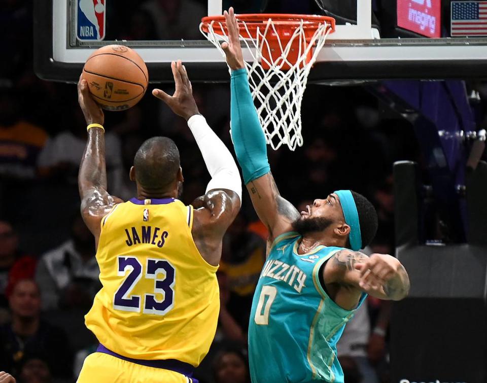 Charlotte Hornets forward Miles Bridges, right, attempts to stop Los Angeles Lakers forward LeBron James, left, on a drive to the basket during first half action on Monday, February 5, 2024 at Spectrum Center in Charlotte, NC.