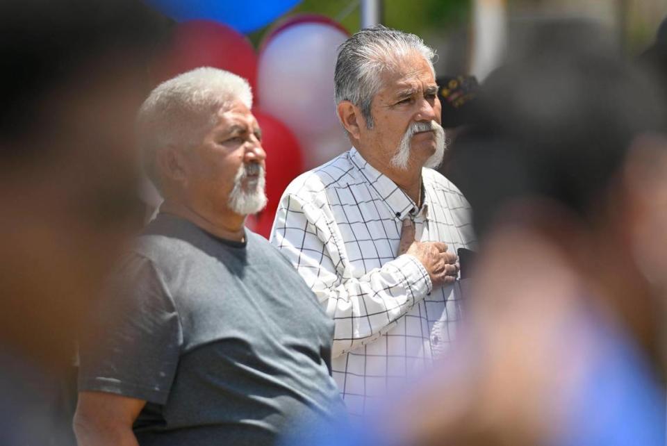 John Zapata, left, stands alongside his brother Marcelino Zapata, right, whose father fought on Iwo Jima and Okinawa in World War II, at the 60th VFW Memorial Day Service held at Fresno Memorial Gardens Monday, May 29, 2023 in Fresno.