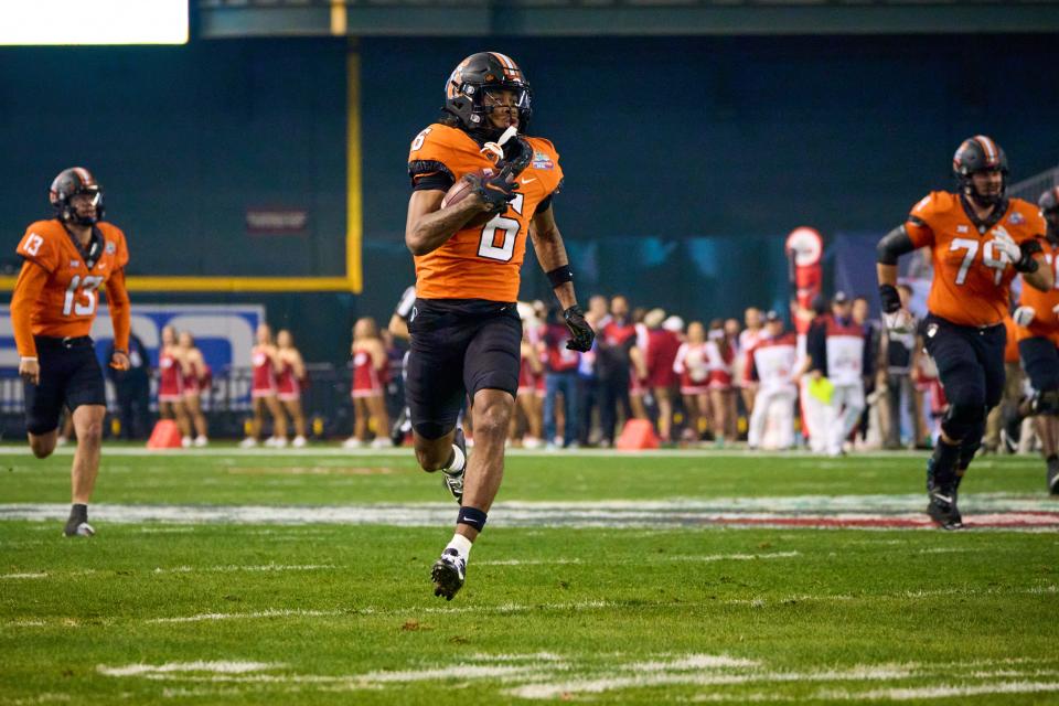 Oklahoma State Cowboys wide receiver Stephon Johnson Jr. (6) runs the ball against the Wisconsin Badgers during the Guaranteed Rate Bowl Game at Chase Field on Tuesday, Dec. 27, 2022.