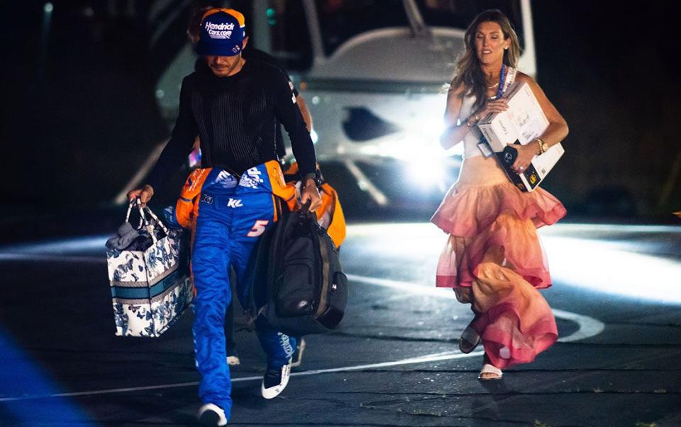 Kyle Larson and wife Katelyn emerge from the helicopter at Charlotte