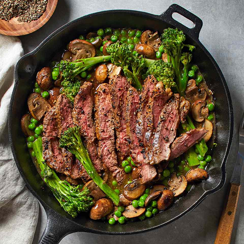 <p>This steak, broccolini and pea dinner is a one-skillet meal that will be on your table in just 25 minutes! The pan drippings combine with mushrooms, broth and grainy mustard to make a thick and delicious sauce. <a href="https://www.eatingwell.com/recipe/266579/skillet-steak-with-mushroom-sauce/" rel="nofollow noopener" target="_blank" data-ylk="slk:View Recipe" class="link ">View Recipe</a></p>
