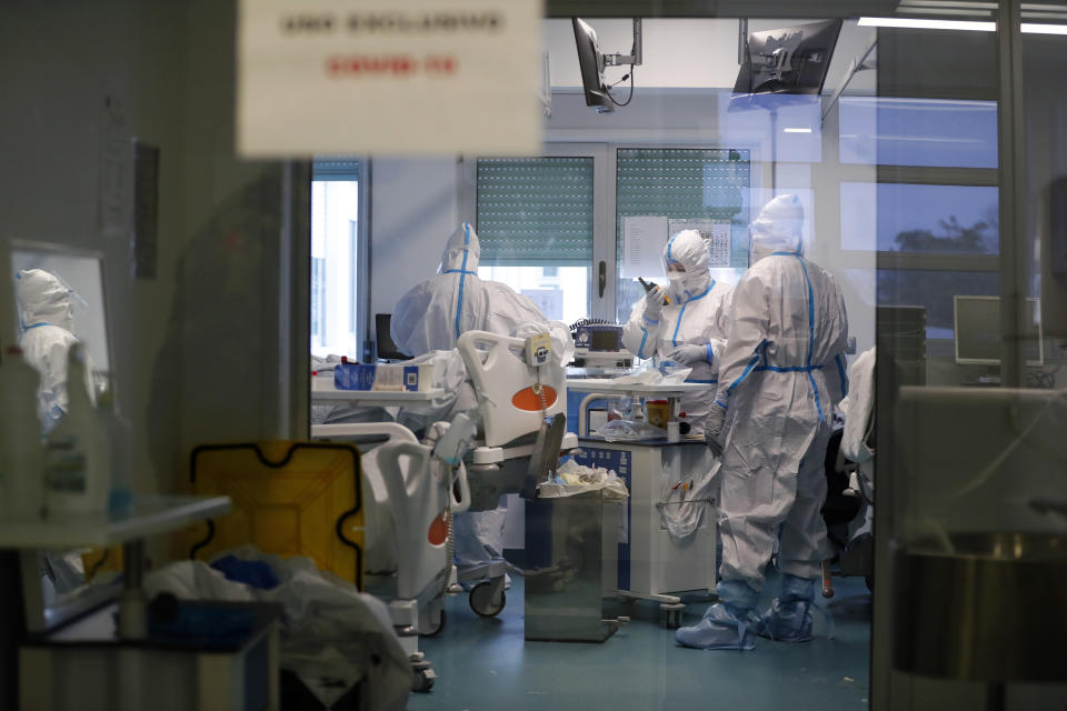 Medical personnel work inside a COVID-19 Intensive Care Unit at the military hospital in Lisbon, Wednesday, Jan. 27, 2021. The military hospital is expanding it's number of beds available to take COVID-19 patients from the National Health Service. Portugal is reporting new daily records of COVID-19 deaths and hospitalizations as a recent pandemic surge continues unabated. (AP Photo/Armando Franca)