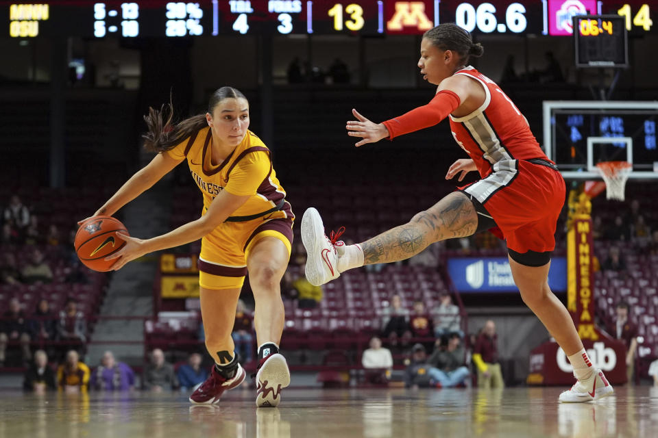 Minnesota guard Maggie Czinano, left, looks to pass the ball as Ohio State guard Rikki Harris defends during the first half of an NCAA college basketball game Thursday, Feb. 8, 2024, in Minneapolis. (AP Photo/Abbie Parr)