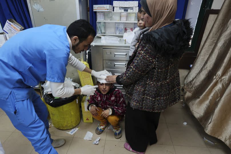 A Palestinian child wounded in an Israeli airstrike is brought to Al Aqsa Hospital in Deir al Balah, Gaza Strip