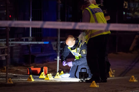 Police forensics investigate the scene after people were shot and injured outside an Internet cafe on Drottninggatan street in central Malmo, southern Sweden, June 18, 2018. TT News Agency/Johan Nilsson/via REUTERS