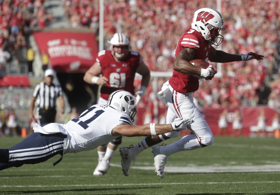 BYU's Austin Lee trips up Wisconsin's Kendric Pryor during the first half of an NCAA college football game Saturday, Sept. 15, 2018, in Madison, Wis. (AP Photo/Morry Gash)