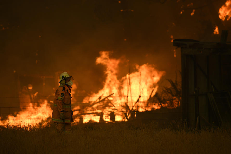 NSW Rural Fire Service crews fight the Gospers Mountain Fire as it impacts a property at Bilpin.