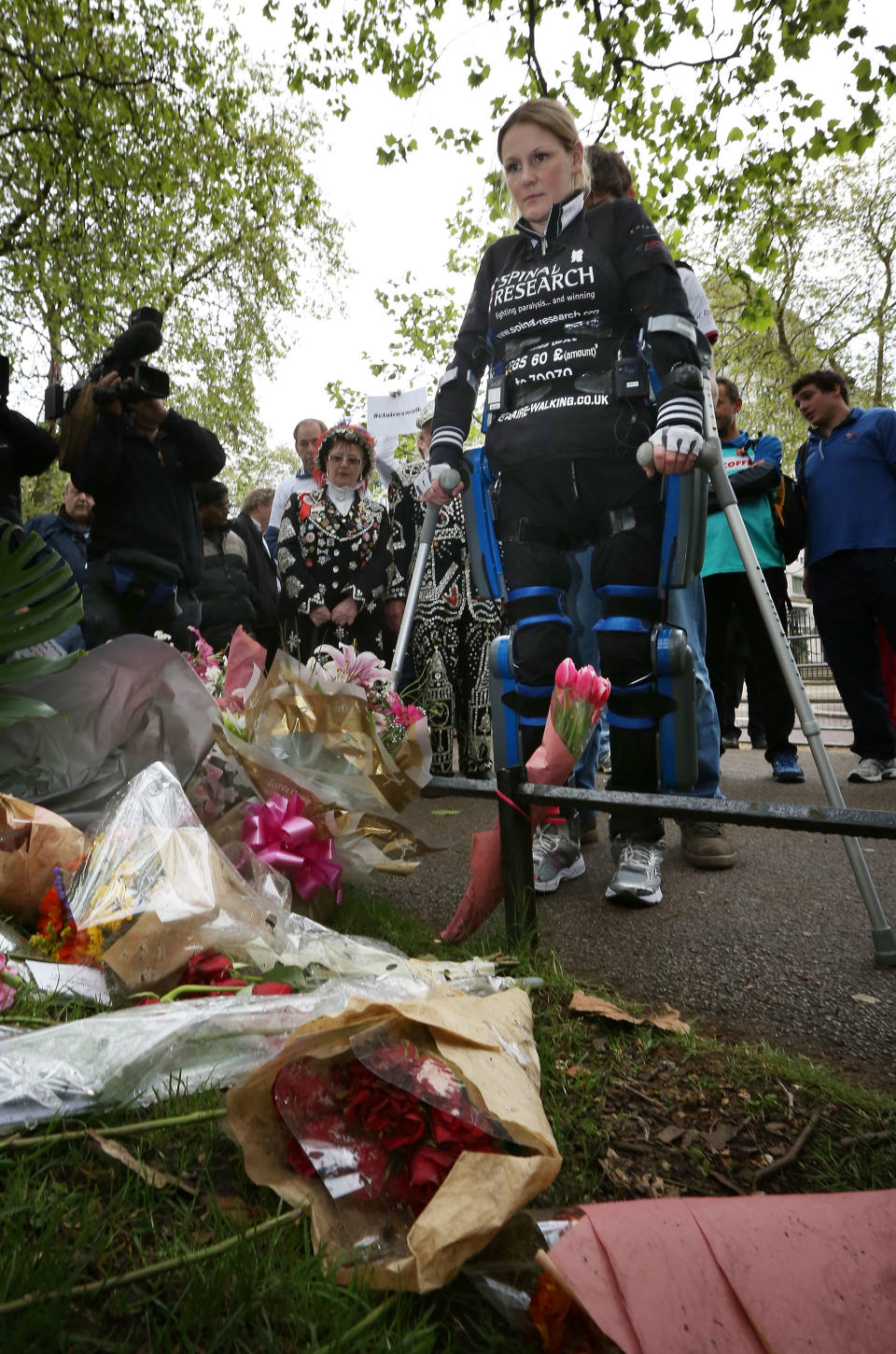 LONDON, ENGLAND - MAY 08: Claire Lomas stands at a floral tribute to Claire Squires who died running the Virgin London Marathon on May 8, 2012 in London, England. Ms Lomas, who is paralysed from the waist down after a riding accident in 2007, has taken 16 days to complete the 26.2 mile route. Starting out with 36,000 other runners she has averaged 2 miles a day with the help of a bionic ReWalk suit. (Photo by Peter Macdiarmid/Getty Images)