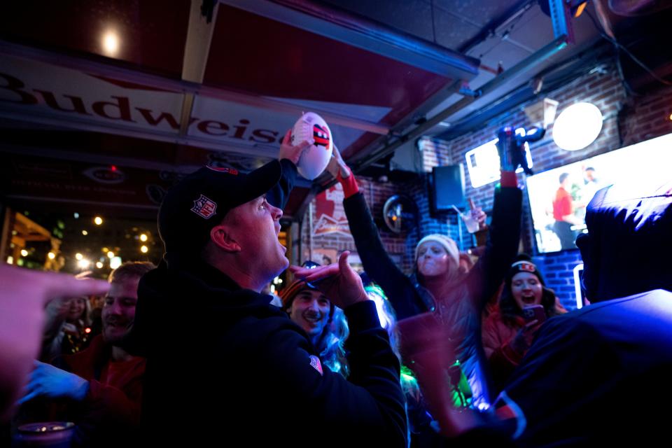 Cincinnati Bengals head coach Zac Taylor delivers a game ball to the Blind Pig after the Bengals defeat the Baltimore Ravens 24-17 in an NFL wild-card playoff game.