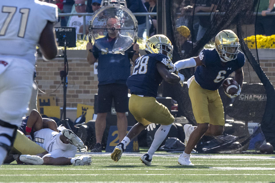 Notre Dame cornerback Clarence Lewis (6) picks up a fumble and runs down the field during the second quarter of an NCAA college football game against UNLV, Saturday, Oct. 22, 2022, in South Bend, Ind. (AP Photo/Marc Lebryk)