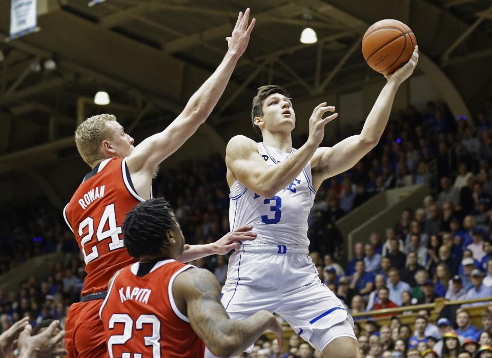 Duke's Grayson Allen (3) drives to the basket while N.C. State's Maverick Rowan (24) and Ted Kapita (23) defend during the first half of an NCAA college basketball game in Durham, N.C., Monday, Jan. 23, 2017. (AP Photo/Gerry Broome)