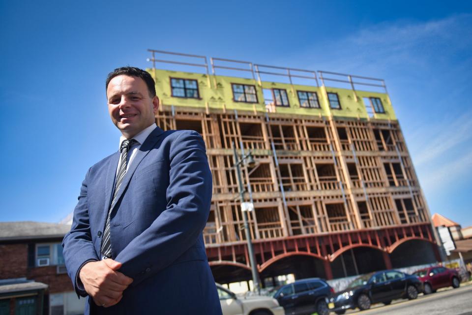 Mayor Andre Sayegh in front of a retail and residential mixed development under construction in South Paterson last August.