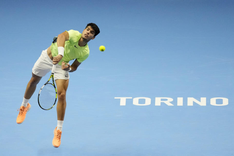 Spain's Carlos Alcaraz returns the ball to Russia's Daniil Medvedev during their singles tennis match of the ATP World Tour Finals at the Pala Alpitour, in Turin, Italy, Friday, Nov. 17, 2023. (AP Photo/Antonio Calanni)