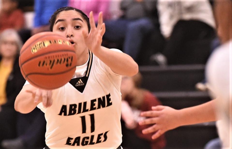 Abilene High's Ariana Trevino passes the ball to a teammate in the second half against Snyder.