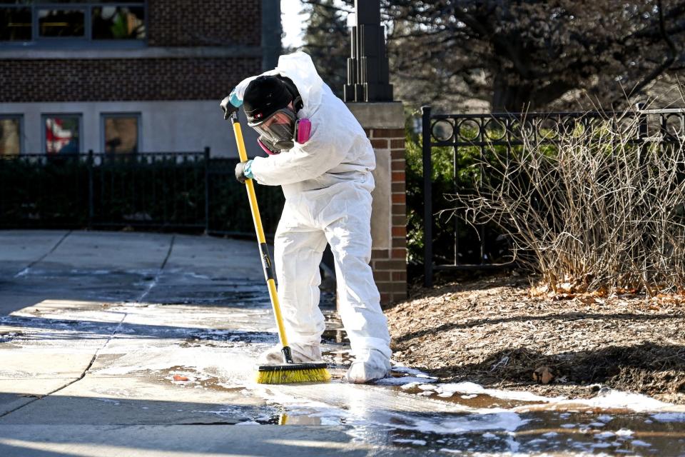 A crew member cleans up the sidewalk outside the MSU Union on Tuesday, Feb. 14, 2023, on the Michigan State campus in East Lansing.