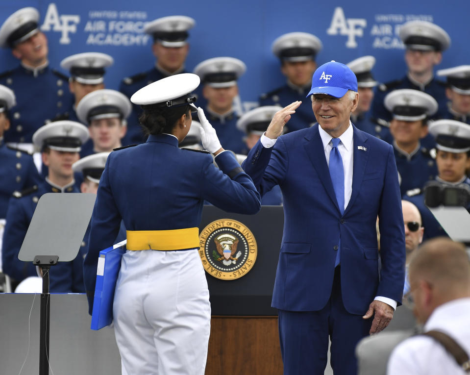 A Cadet receives her diploma as she salutes President Joe Biden during the United States Air Force Academy graduation ceremony Thursday, June 1, 2023, at Air force Academy, Colo. (AP Photo/John Leyba)