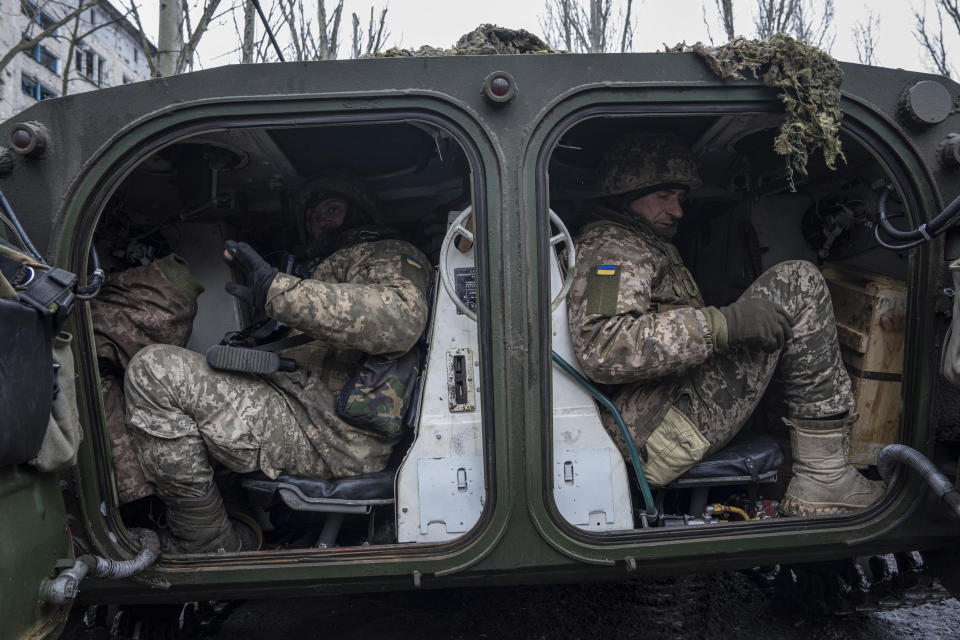 Ukrainian marine servicemen sit inside a APC before going to the position, in the frontline in the city of Vuhledar, Ukraine, Saturday, Feb. 25, 2023. (AP Photo/Evgeniy Maloletka)