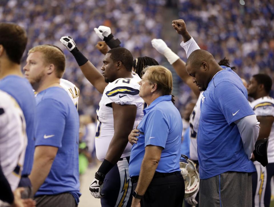 <p>Members of the San Diego Chargers raise their fist during the playing of the national anthem before an NFL football game against the Indianapolis Colts, Sunday, Sept. 25, 2016, in Indianapolis. (AP Photo/Jeff Roberson) </p>