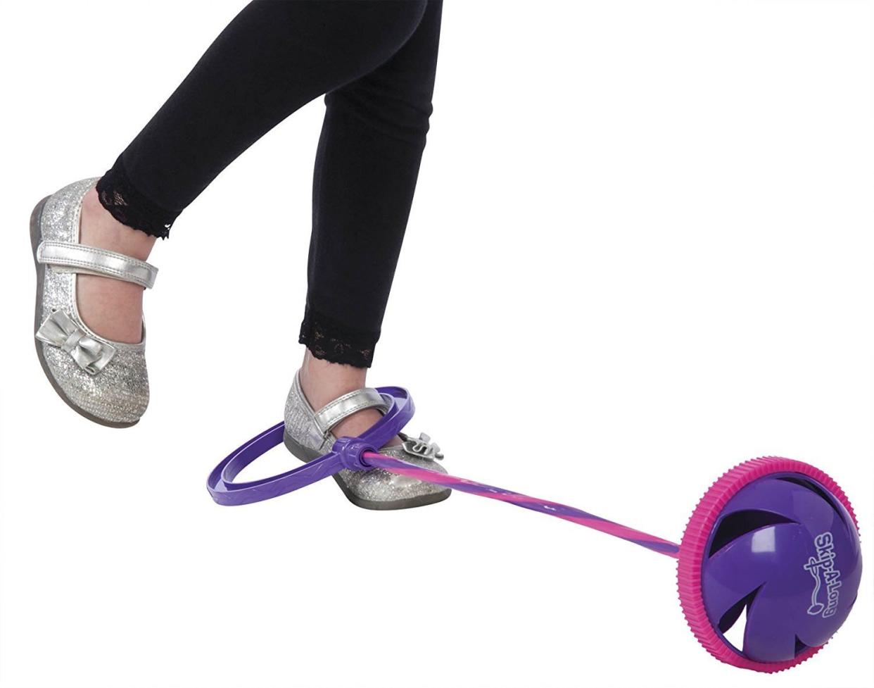 Child with a Skip It toy around her ankle