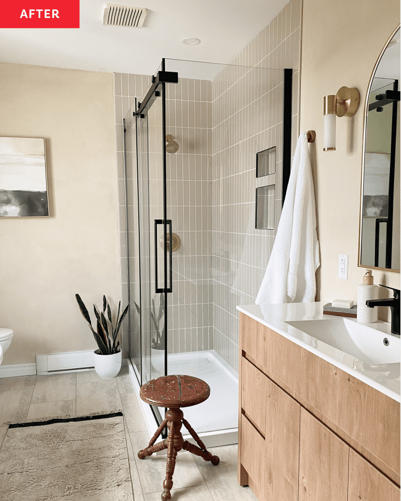 After: Bathroom with tan walls, modern vanity, and standing shower with glass doors