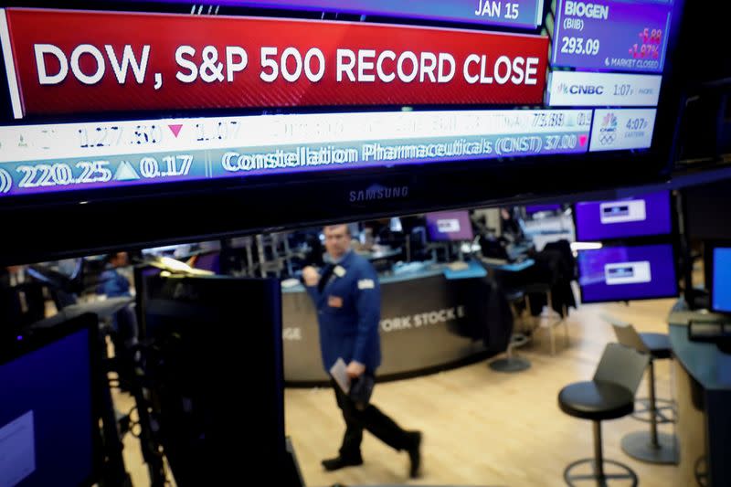 FILE PHOTO: Traders work on the floor at the NYSE in New York