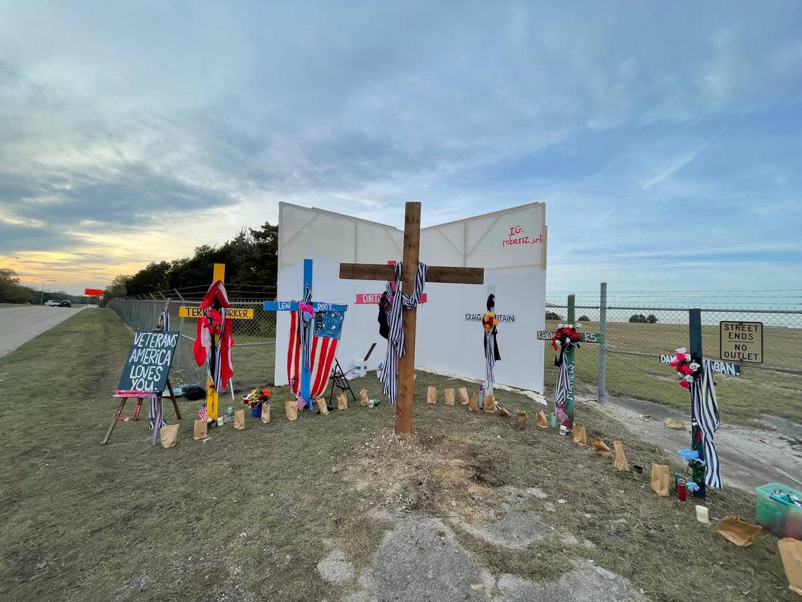 A memorial set up by local artist Roberto Marquez outside the Dallas Executive Airport has six crosses, each with a name of one of the six men killed in the air show crash there Saturday, and will soon have a mural to accompany it.