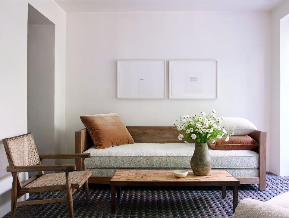 This small sitting room, which opens into a leafy courtyard, has a custom-made wooden sofa modeled after a Jean-Michel Frank design, paired with a tile-and-steel Roger Capron coffee table from the '60s and a rare Pierre Jeanneret “Chandigarh” armchair with turned legs (most pieces from this 1950s collection have V-shaped angular legs).