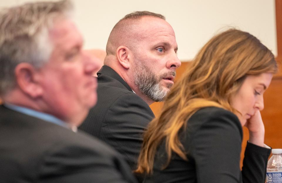 Michael Jason Meade sits with Defense Attorneys Mark Collins and Kaitlyn Stephens while they wait for court to begin in the trial of Michael Jason Meade at the Franklin County Common Pleas Court.
(Credit: Brooke LaValley/Columbus Dispatch)