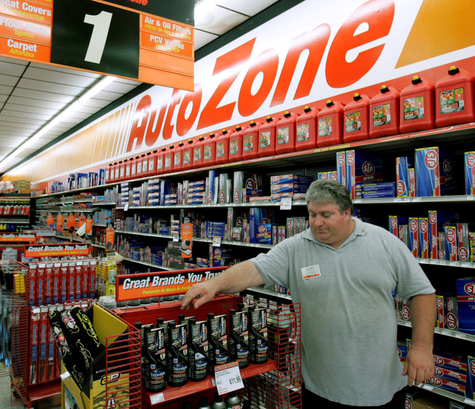 FILE - In this May 26, 2009 file photo, AutoZone employee Pat Wortwick works on a store display in Tallahassee, Fla. (AP Photo/Phil Coale, File)