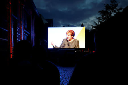 German Chancellor Angela Merkel, a top candidate of the Christian Democratic Union Party (CDU) for the upcoming general elections, is seen speaking on a big screen during an election rally in Hamburg, Germany, September 20, 2017. REUTERS/Morris Mac Matzen